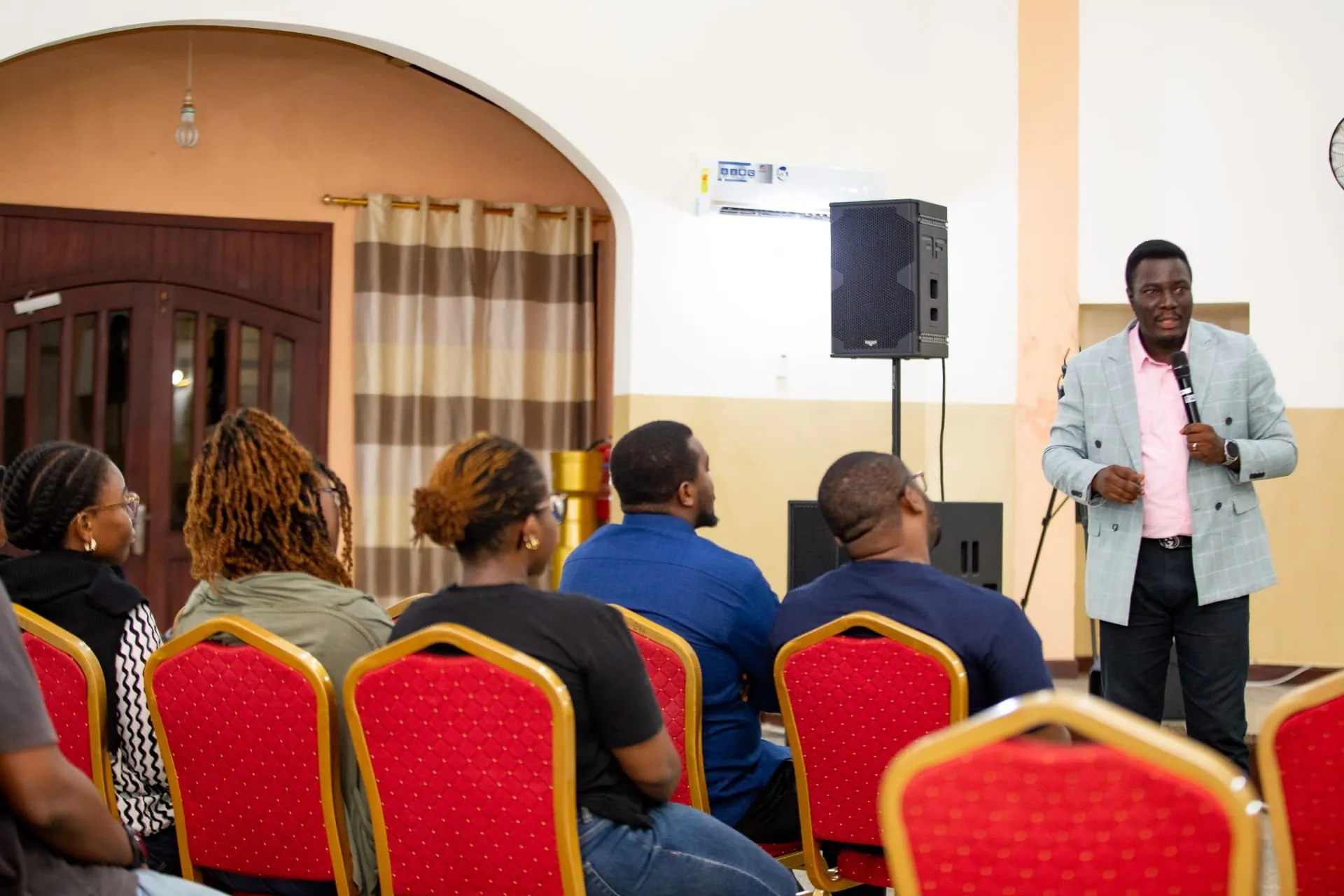 A speaker teaching a seated group during a Faith Camp session