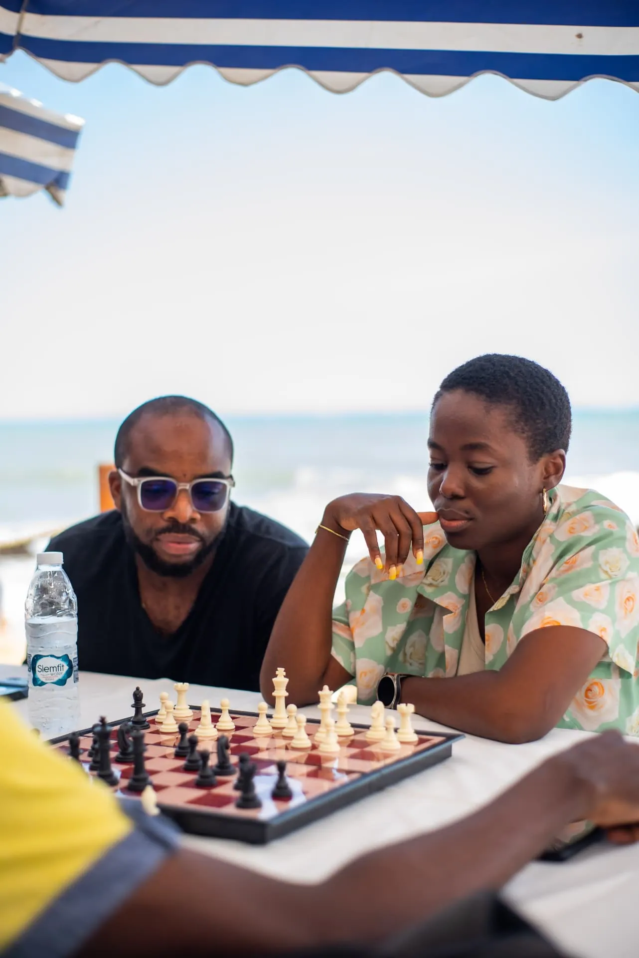 Members playing chess together by the sea