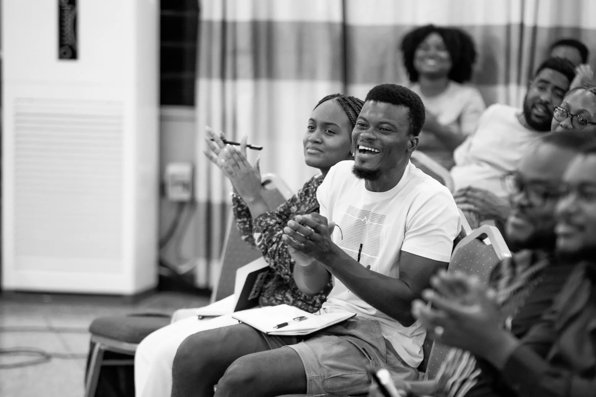 Members clapping and laughing during a Faith Camp session