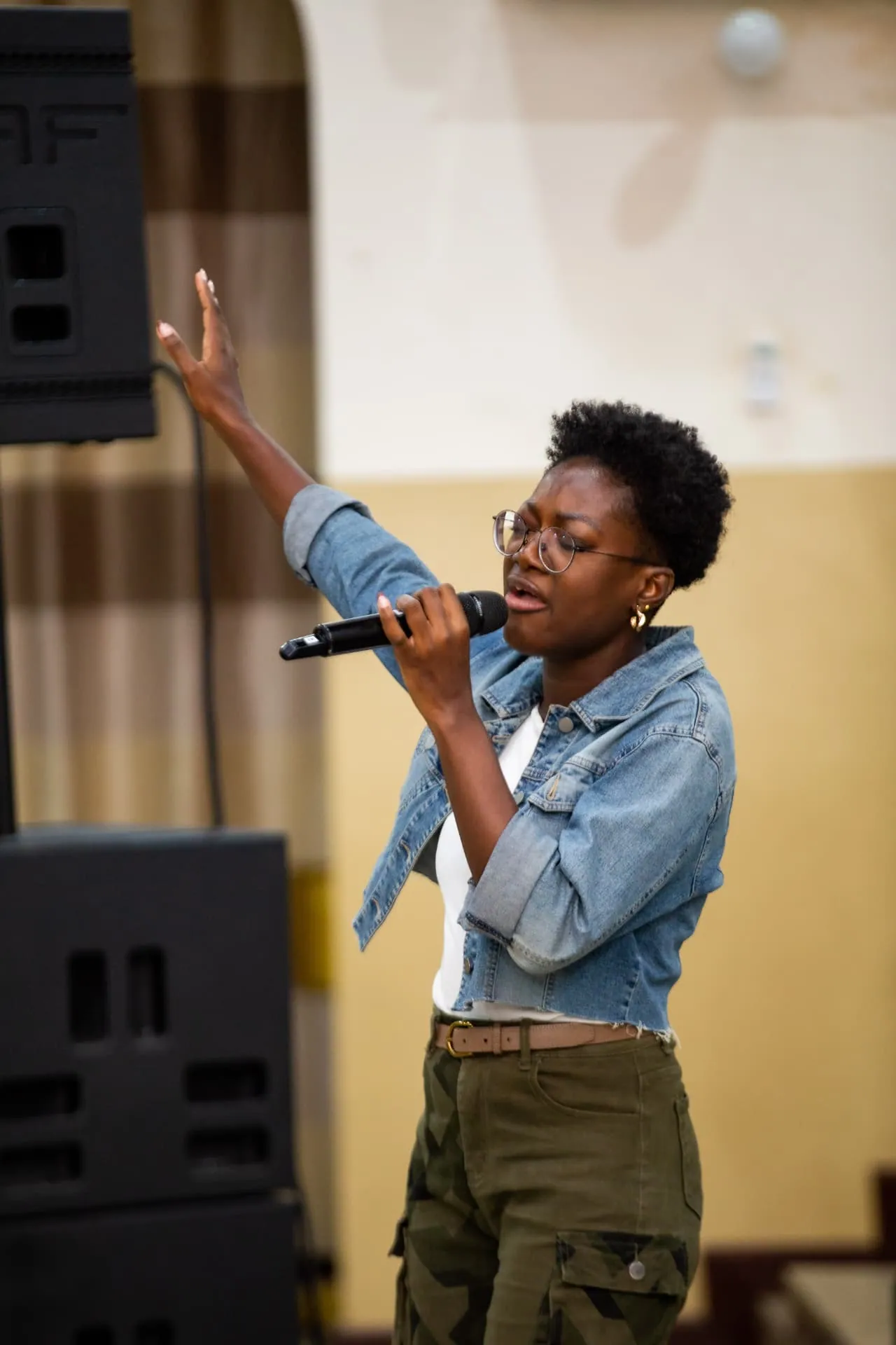A worship leader singing at Faith Camp
